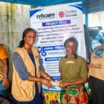 Beneficiaries from Western Area Urban communities receive cash assistance through a Caritas Freetown disaster preparedness project