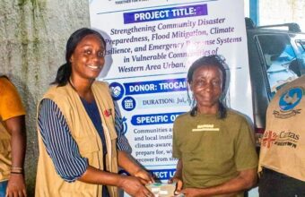 Beneficiaries receive cash assistance through a Caritas Freetown disaster-preparedness project in Wellington